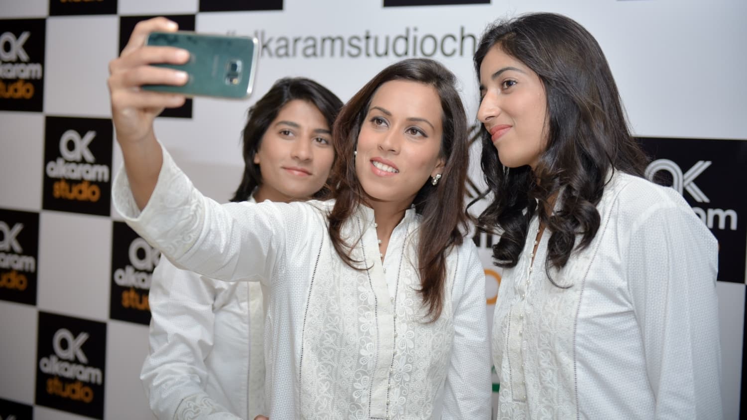 A digitally printed silk scarf accompanies the outfit.